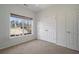 Bright bedroom featuring a large window and double door closet at 160 Glenmore Ln, Mcdonough, GA 30253
