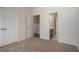 Bedroom with neutral walls and carpet; view into ensuite bathroom at 160 Glenmore Ln, Mcdonough, GA 30253