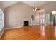 Spacious living room with fireplace, hardwood floors and elegant lighting at 160 Glenmore Ln, Mcdonough, GA 30253