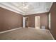 Spacious main bedroom featuring trey ceilings, fan, and neutral carpet at 160 Glenmore Ln, Mcdonough, GA 30253