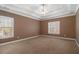 Spacious main bedroom with a tray ceiling and neutral carpet flooring at 160 Glenmore Ln, Mcdonough, GA 30253