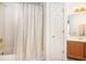 Bathroom featuring a tub with a shower curtain, tile surround, and vanity at 3287 Rose Rdg, Atlanta, GA 30340