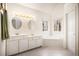 Bathroom with double vanity, soaking tub under windows, and neutral tile flooring at 3287 Rose Rdg, Atlanta, GA 30340