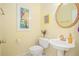 Cozy half-bath featuring decorative artwork, a pedestal sink, and a charming design at 3287 Rose Rdg, Atlanta, GA 30340