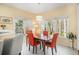Bright dining area with a wooden table, four orange chairs, and natural light at 3287 Rose Rdg, Atlanta, GA 30340