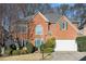Charming brick home features lush landscaping and a well-maintained front yard at 3287 Rose Rdg, Atlanta, GA 30340