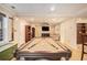 Spacious game room featuring a pool table, fireplace, and built-in bookshelves at 3287 Rose Rdg, Atlanta, GA 30340