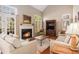 Bright living room featuring a fireplace, large windows, and comfortable seating area at 3287 Rose Rdg, Atlanta, GA 30340