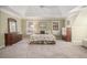 Bright main bedroom with neutral walls, carpet, furnishings, ceiling fan and trey ceiling at 3287 Rose Rdg, Atlanta, GA 30340