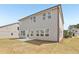 Large backyard featuring a new patio and house with light gray siding at 6910 Winchester Pl, Fairburn, GA 30213