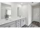 Modern bathroom featuring a double vanity with grey cabinets and sleek hardware at 6910 Winchester Pl, Fairburn, GA 30213