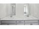 Modern bathroom featuring double sinks, white countertops, and elegant fixtures at 6910 Winchester Pl, Fairburn, GA 30213