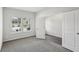 Carpeted bedroom featuring an adjoining room, a window, and a closet with double doors at 6910 Winchester Pl, Fairburn, GA 30213