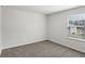A cozy carpeted bedroom with a window for natural light at 6910 Winchester Pl, Fairburn, GA 30213