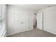 Carpeted bedroom with a double door closet providing convenient storage at 6910 Winchester Pl, Fairburn, GA 30213