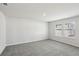 Spacious bedroom featuring carpeting and a large double window for natural light at 6910 Winchester Pl, Fairburn, GA 30213
