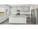 Bright kitchen featuring an island, stainless steel appliances and gray cabinets at 6910 Winchester Pl, Fairburn, GA 30213