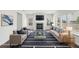 Staged living room featuring a fireplace, hardwood floors and an area rug at 6910 Winchester Pl, Fairburn, GA 30213