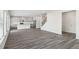 Spacious living room that flows into the kitchen with hard surface flooring and natural light at 6910 Winchester Pl, Fairburn, GA 30213