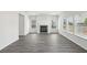 Bright living room with hardwood floors, a fireplace and multiple windows at 6910 Winchester Pl, Fairburn, GA 30213
