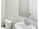 Modern powder room with a sleek mirror, stylish fixtures, and crisp white walls at 6910 Winchester Pl, Fairburn, GA 30213