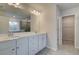 Bright bathroom with double sink vanity, large mirror, tile floors, and access to the closet at 254 Arnewood Cir, Mcdonough, GA 30253