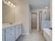 Bright bathroom with double sink vanity, walk-in shower, and separate soaking tub at 254 Arnewood Cir, Mcdonough, GA 30253