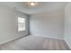 Bright bedroom features plush carpeting, neutral paint, and a window providing natural light at 254 Arnewood Cir, Mcdonough, GA 30253