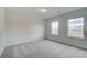Bedroom with neutral walls, carpet, windows, and natural light at 254 Arnewood Cir, Mcdonough, GA 30253