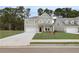 Charming two-story home with a well-manicured lawn, a driveway, and an attached garage at 254 Arnewood Cir, Mcdonough, GA 30253