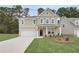 A spacious two-story home with a wide driveway, lush front yard, and a welcoming covered entryway at 254 Arnewood Cir, Mcdonough, GA 30253
