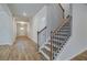 Hallway with wood floors leading to a staircase and a front door at 254 Arnewood Cir, Mcdonough, GA 30253