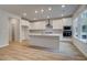 Modern kitchen with white cabinets, stainless steel appliances, and a central island offering ample counter space at 254 Arnewood Cir, Mcdonough, GA 30253
