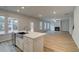 Spacious kitchen flows to living room with fireplace, features stainless steel sink and ample counter space at 254 Arnewood Cir, Mcdonough, GA 30253