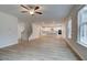 Open-concept living room featuring a ceiling fan, hardwood floors, and a staircase leading to the upper level at 254 Arnewood Cir, Mcdonough, GA 30253