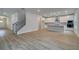 An expansive living space showcases an open staircase adjacent to the kitchen, with hardwood floors throughout at 254 Arnewood Cir, Mcdonough, GA 30253