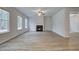 Bright living room with wood floors, modern fireplace, and large windows at 254 Arnewood Cir, Mcdonough, GA 30253