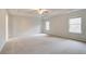 Spacious main bedroom features tray ceiling, neutral paint, plush carpeting, and large windows at 254 Arnewood Cir, Mcdonough, GA 30253