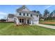 Beautiful two-story home featuring a lush green lawn, a cozy porch, and an attached garage at 138 Crabbswood Dr, Mcdonough, GA 30253
