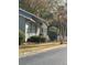View of a townhouse featuring a black metal fence surrounding the property and lush greenery at 2340 Beaver Ruin Rd, Norcross, GA 30071