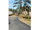 View of townhouse complex featuring mature trees, manicured shrubs, and community at 2340 Beaver Ruin Rd, Norcross, GA 30071