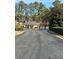 Exterior shot of townhouse complex featuring mature trees, manicured shrubs, and community pool at 2340 Beaver Ruin Rd, Norcross, GA 30071