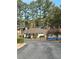 View of townhouse complex featuring mature trees, manicured shrubs, and outdoor swimming pool at 2340 Beaver Ruin Rd, Norcross, GA 30071