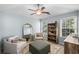 A bright bedroom with natural lighting showcases an accent mirror, comfy chairs, and decor at 2360 Brookgreen Commons, Kennesaw, GA 30144