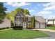 Charming two-story home with manicured lawn, attached garages, and welcoming curb appeal at 2360 Brookgreen Commons, Kennesaw, GA 30144