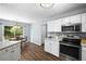 Bright eat-in kitchen features stainless steel appliances, granite countertops, and backyard access at 2360 Brookgreen Commons, Kennesaw, GA 30144
