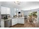 Beautiful open kitchen with stainless appliances, white cabinets, and seamless flow to dining area at 2360 Brookgreen Commons, Kennesaw, GA 30144