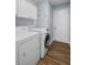 A convenient laundry room includes a washer, dryer, and overhead storage cabinets at 2360 Brookgreen Commons, Kennesaw, GA 30144