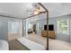A beautifully decorated bedroom with lots of space, a four-poster bed, and soft natural light at 2360 Brookgreen Commons, Kennesaw, GA 30144