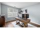 Bright home office featuring a modern desk, a large window, and wood flooring at 2360 Brookgreen Commons, Kennesaw, GA 30144
